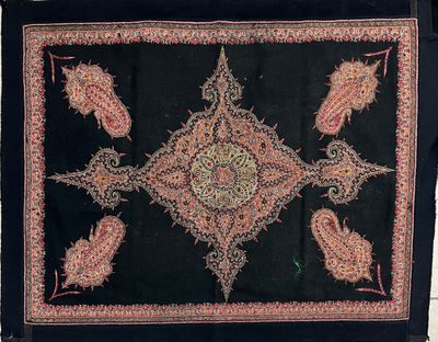 an image of a black and red rug with paisley designs on it