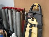 a yellow and black vacuum sitting next to a pile of assorted items