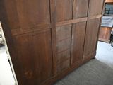 an image of a large wooden cabinet in a room