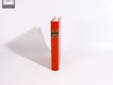 un livre rouge d'où sort un crayon