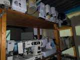 many sewing machines sitting on a shelf in a room