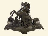 a bronze statue of a horse and a man on a horse