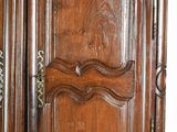a large wooden cabinet with a door and a drawer