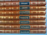 several books stacked on top of each other on a blue surface
