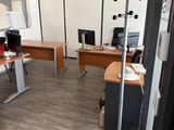 an image of an office with two desks and a chair
