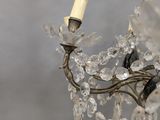 a chandelier made of glass beads and a candle
