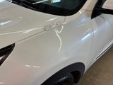 a close up of a white car in a showroom