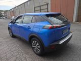 the rear end of a blue toyota c - hr parked in a parking lot