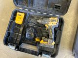 two tools in a case on the floor next to a pair of shoes