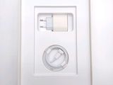 a white box with a charger and a cable in it