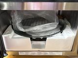 a microwave that has a bag in it on top of it