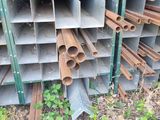 a pile of steel pipes stacked up on the ground