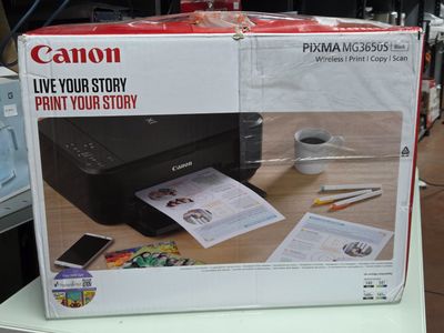 une imprimante Canon posée sur une table dans un magasin