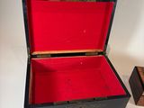 a small wooden box with a red lid on a table