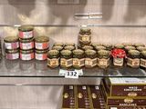 many jars of food on the shelves in the store