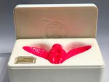 a white box with a pink object inside of it