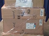 des cartons empilés les uns sur les autres sur une palette, devant un rideau bleu