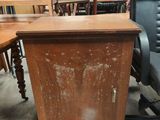 a wooden desk with a black chair next to it