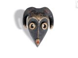 a close up of a black and brown mask on a white surface