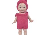 pink knitted baby doll wearing a pink knitted hat and dress