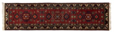 a close up of a red and black rug on a white background