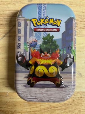 pokemon trading card game in a tin on a wooden table