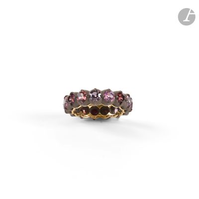 a close up of a ring with three different colored stones