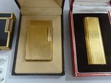 a gold cigarette case with a lighter inside of it