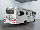 an image of a white motorhome parked in a garage