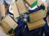 a pile of boxes that are sitting on a bed