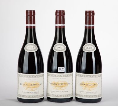 three bottles of wine are lined up on a white surface