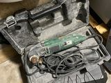 a tool in the case on the floor next to a water heater