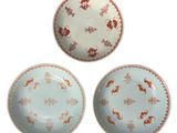 three plates with different designs on them on a white surface