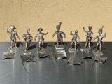 a lot of silver figurines of soldiers on a table