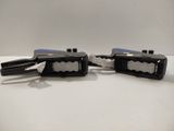 two black and white staplers sitting on a table
