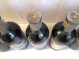 several bottles of wine are lined up on a shelf