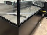 a glass display case in the middle of a room