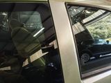 a man sitting in the passenger seat of a car