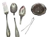 a spoon, fork, and spoon rest on a white surface