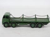 a green toy truck with chains attached to the back of it