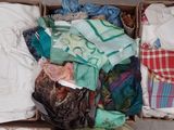 a box full of clothing that is sitting on the floor