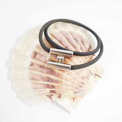leather bracelet with silver plated clasp on a seashell