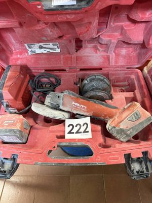 a red car with tools in the trunk of it
