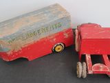 a red toy truck and a wooden box on a table