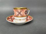 a close up of a cup and saucer on a table