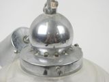 a silver tea pot with a silver lid on a white table