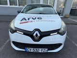 the front of a white car parked in front of a building