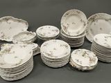 a lot of plates and bowls on the table