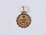 a close up of a gold medal with a cross on it