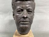 statue of a man ' s head on a marble base
